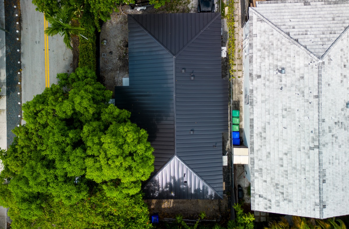 South Florida home exterior showing completed impact window installation — drone view of the finished project